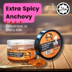 A close-up of extra spicy anchovies arranged on a plate, garnished with herbs and chili flakes, showcasing their vibrant colors.