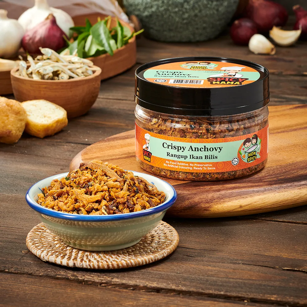 A bowl of crispy anchovy placed on a table beside a jar of spicymama crispy anchovy, creating a cozy dining atmosphere.
