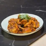A delicious plate of Rendang on a black marble table