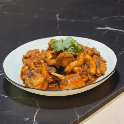 A delicious plate of Rendang on a black marble table