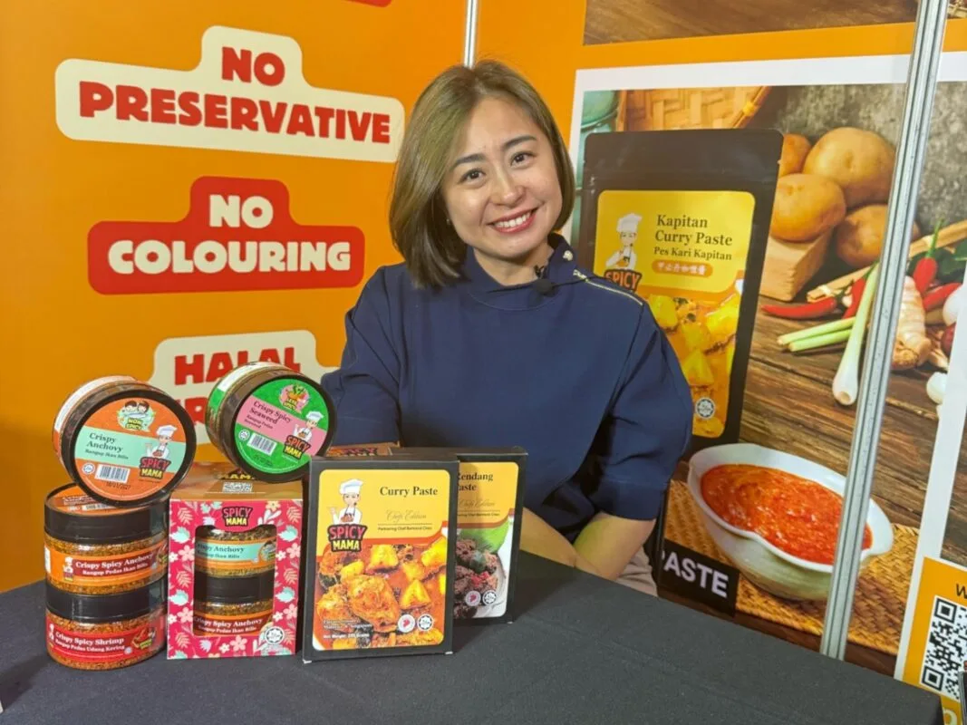 A woman seated at a table surrounded by an assortment of food products, showcasing a variety of colors and textures. at south africa