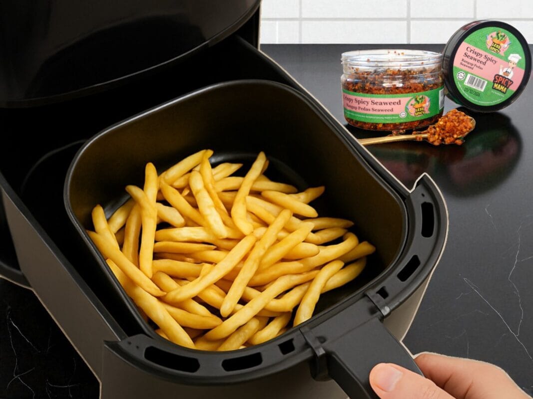 A person presents a basket of steaming French fries, freshly prepared in an air fryer, showcasing a delicious snack SpicyMama Crispy Seaweed