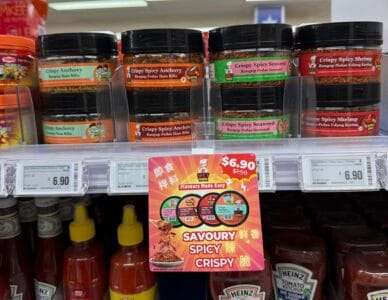  A shelf filled with an array of SpicyMama condiments and sauces, featuring vibrant bottles and jars for culinary use.