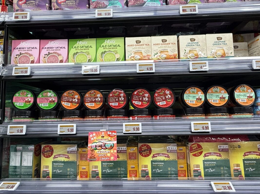 A shelf displaying a variety of SpicyMama Condiments types, showcasing colorful packaging and diverse flavors.