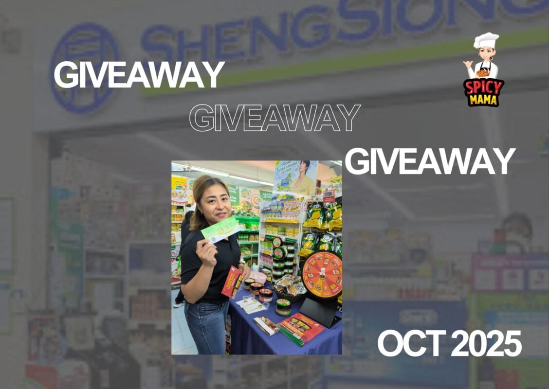 A woman stands with a sign stating "giveaway," promoting an event or contest with enthusiasm.