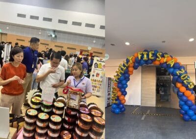 A group of people stands together in front of a colorful food display at an event or gathering.