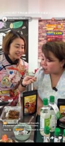 Two women are eating black pepper chicken